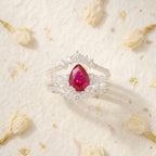 Pear Ruby Cluster Ring with Moissanite Enhancer wedding band Stand on table