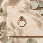 Kite Shaped Moss Agate Engagement Ring Lay Down On Stone