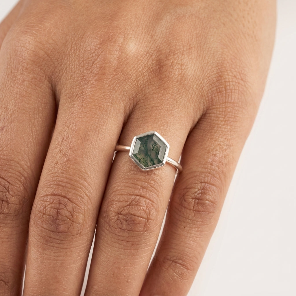 Hexagon Cut Moss Agate Bezel Set Engagement Ring With fingers